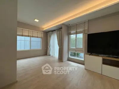 Spacious living room with modern design and large windows for natural light