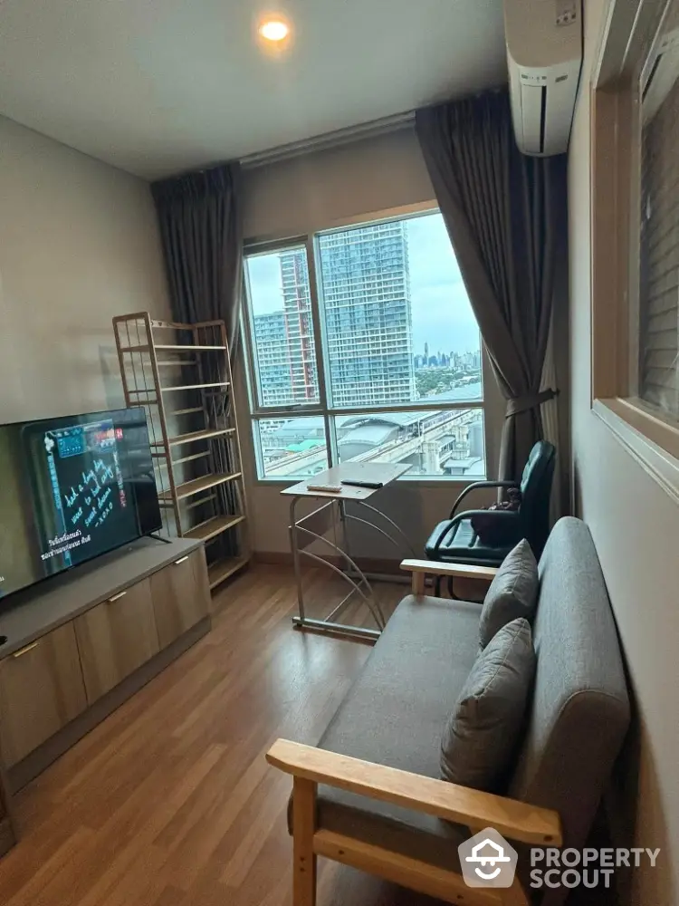 Cozy living room with city view, modern furniture, and large window for natural light.