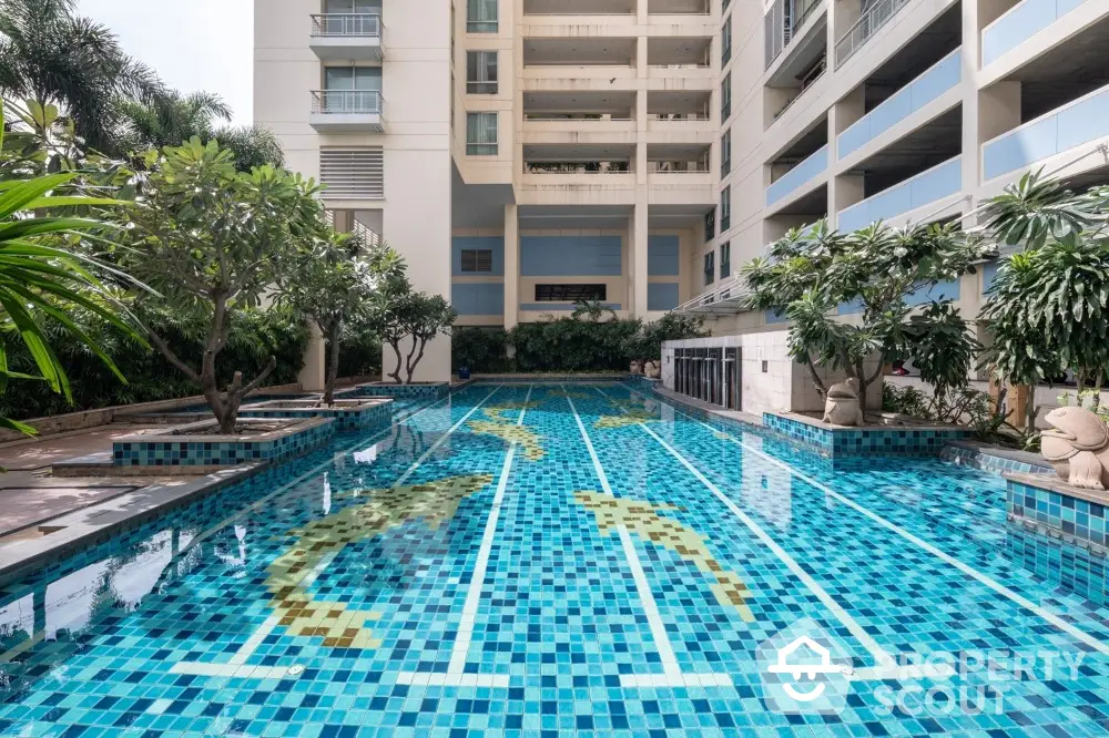 Luxurious residential building with stunning outdoor swimming pool and lush greenery