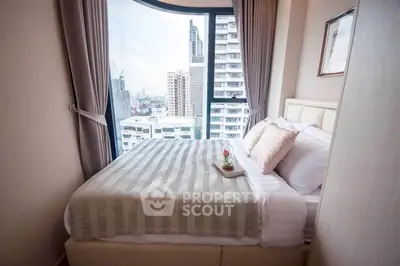 Cozy bedroom with city view in modern high-rise apartment