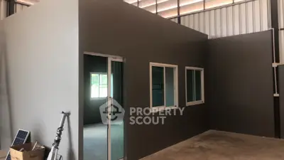 Modern industrial warehouse interior with office space and large windows