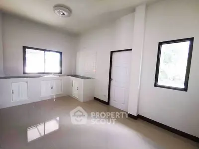 Bright and spacious kitchen with modern design and ample natural light.