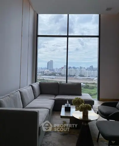 Luxurious living room with panoramic city view, featuring modern furniture and elegant decor.