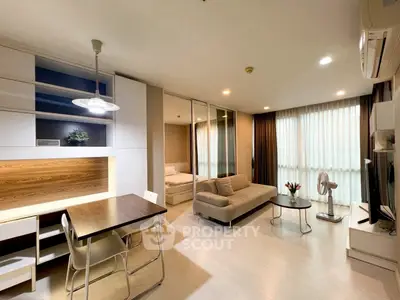 Modern open-plan living room with cozy sofa and stylish dining area