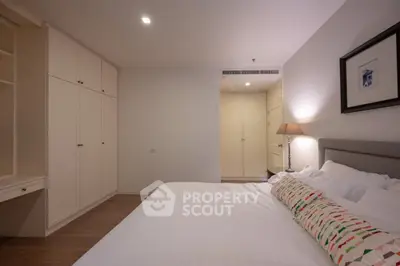 Spacious bedroom with elegant decor and ample storage space