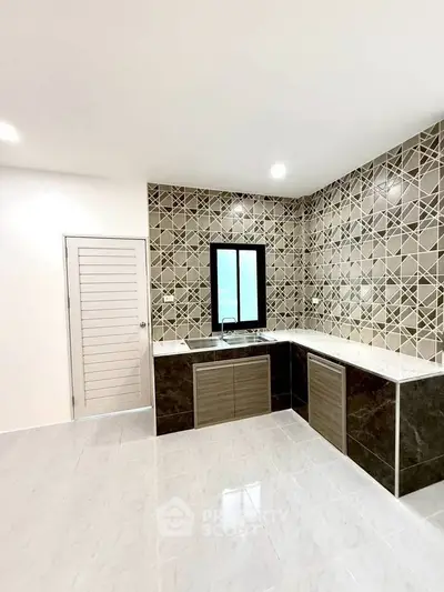 Modern kitchen with stylish tile backsplash and sleek cabinetry