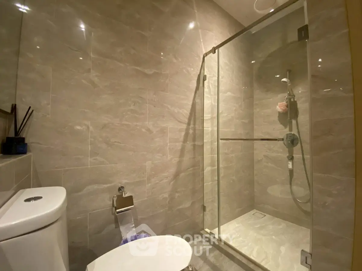 Modern bathroom with glass shower and sleek tile design