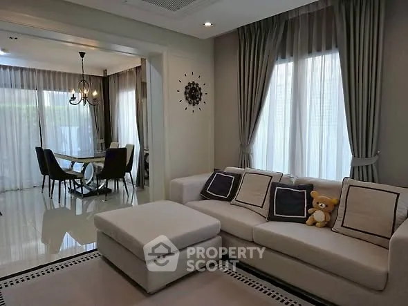 Elegant living room with plush sofa and dining area in modern home