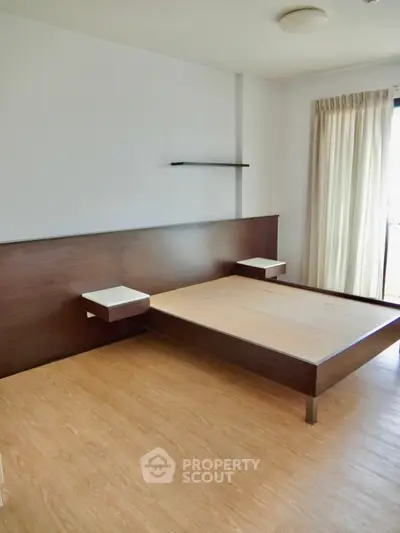 Modern minimalist bedroom with wooden flooring and built-in bed frame