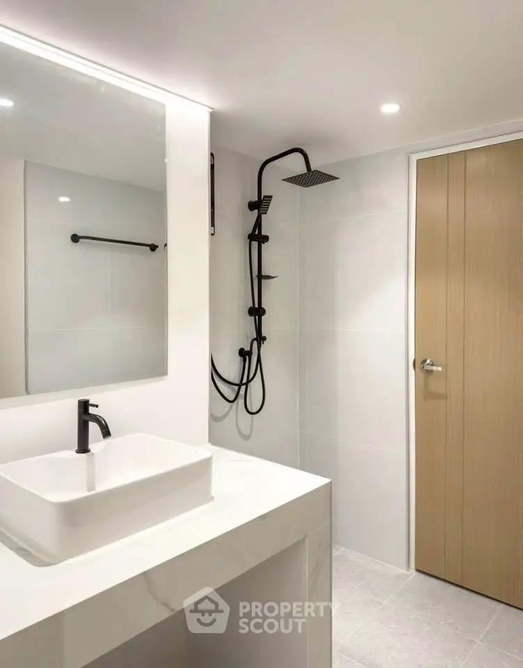 Modern minimalist bathroom with sleek fixtures and elegant design.