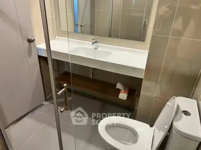 Modern bathroom with sleek fixtures and glass shower enclosure