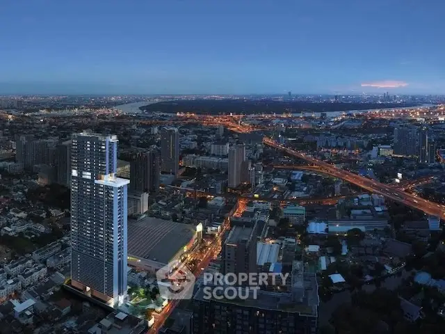 Stunning aerial view of a modern high-rise building in a vibrant cityscape at dusk.
