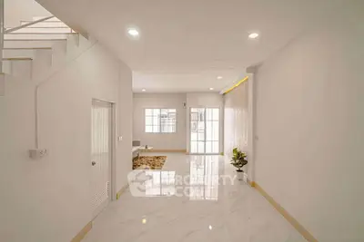 Spacious modern living room with glossy floors and natural light