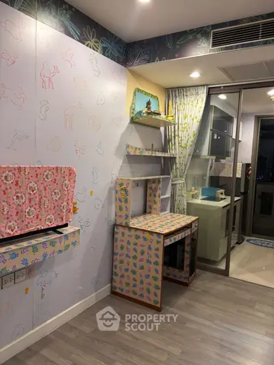Charming study area with playful wallpaper and modern kitchen view, perfect for creative inspiration.