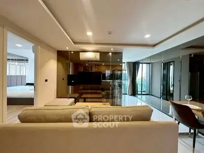 Spacious modern living room with open layout and large windows offering natural light.