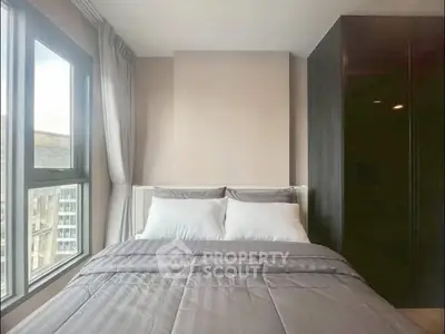 Modern bedroom with large window and stylish wardrobe, offering a cozy and inviting atmosphere.