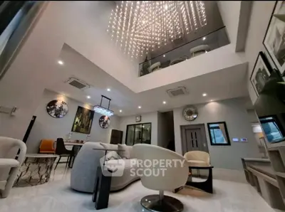 Luxurious modern living room with high ceiling and elegant chandelier
