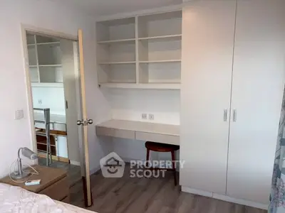 Modern bedroom with built-in desk and storage, ideal for efficient living.