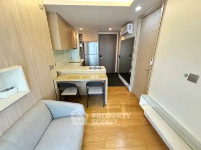 Modern compact living room with open kitchen and sleek design