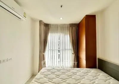 Bright and cozy bedroom with large window and elegant curtains in modern apartment.