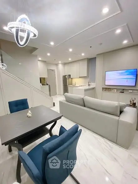 Modern open-plan living room with stylish dining area and sleek kitchen