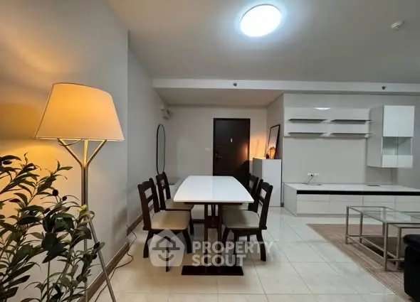 Modern dining area with elegant furniture and ambient lighting in a stylish apartment.