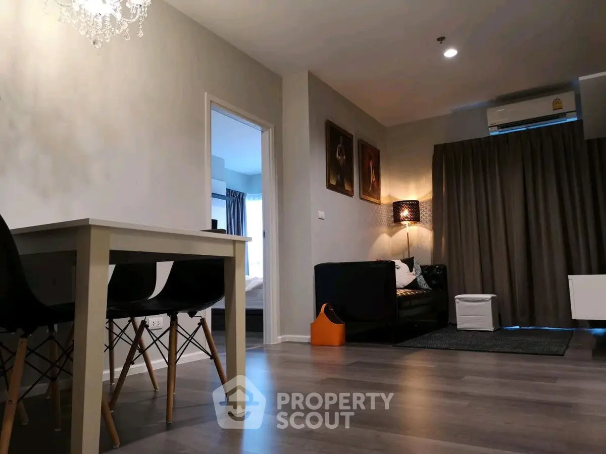 Modern living room with elegant decor and dining area in a stylish apartment.