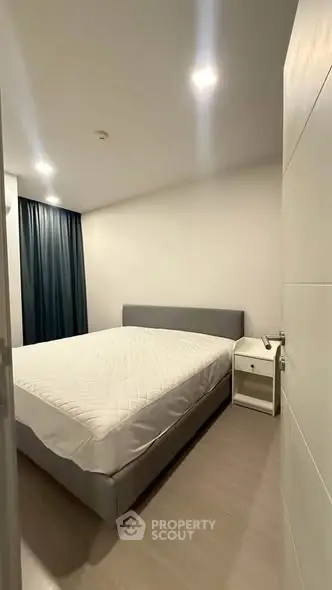 Modern minimalist bedroom with sleek design and cozy ambiance.