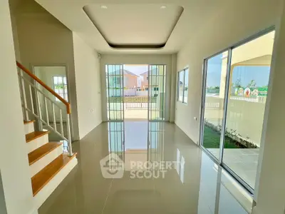 Spacious modern living room with large windows and garden view