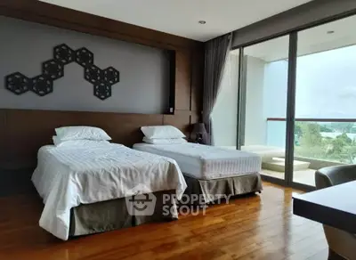 Modern bedroom with twin beds and balcony view in luxury apartment