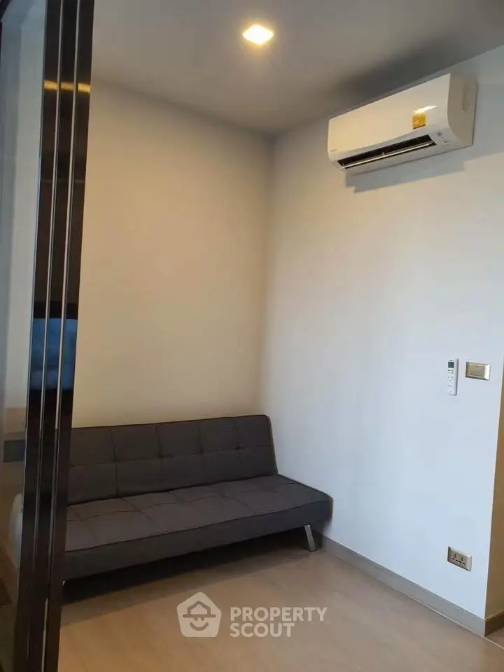 Cozy small room with sofa and air conditioning, perfect for a compact living space.