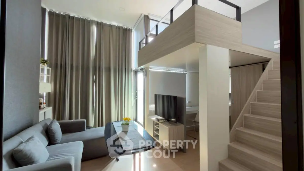 Modern loft-style living room with high ceilings and stylish decor