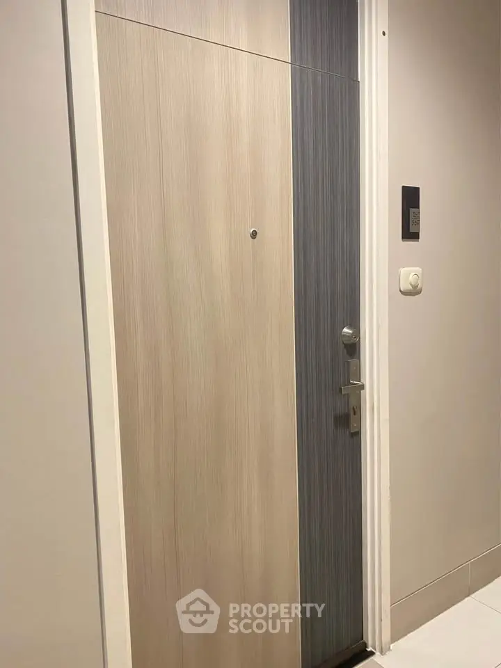 Modern apartment entrance door with sleek design and secure lock system.