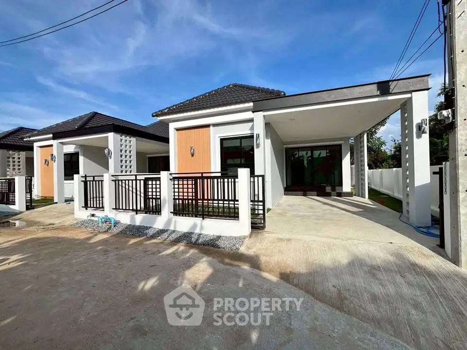 Modern single-story house with sleek design and spacious driveway