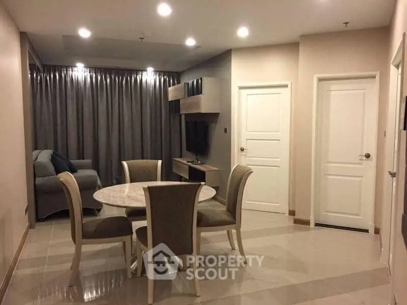 Modern living room with dining area and stylish furniture in a cozy apartment.