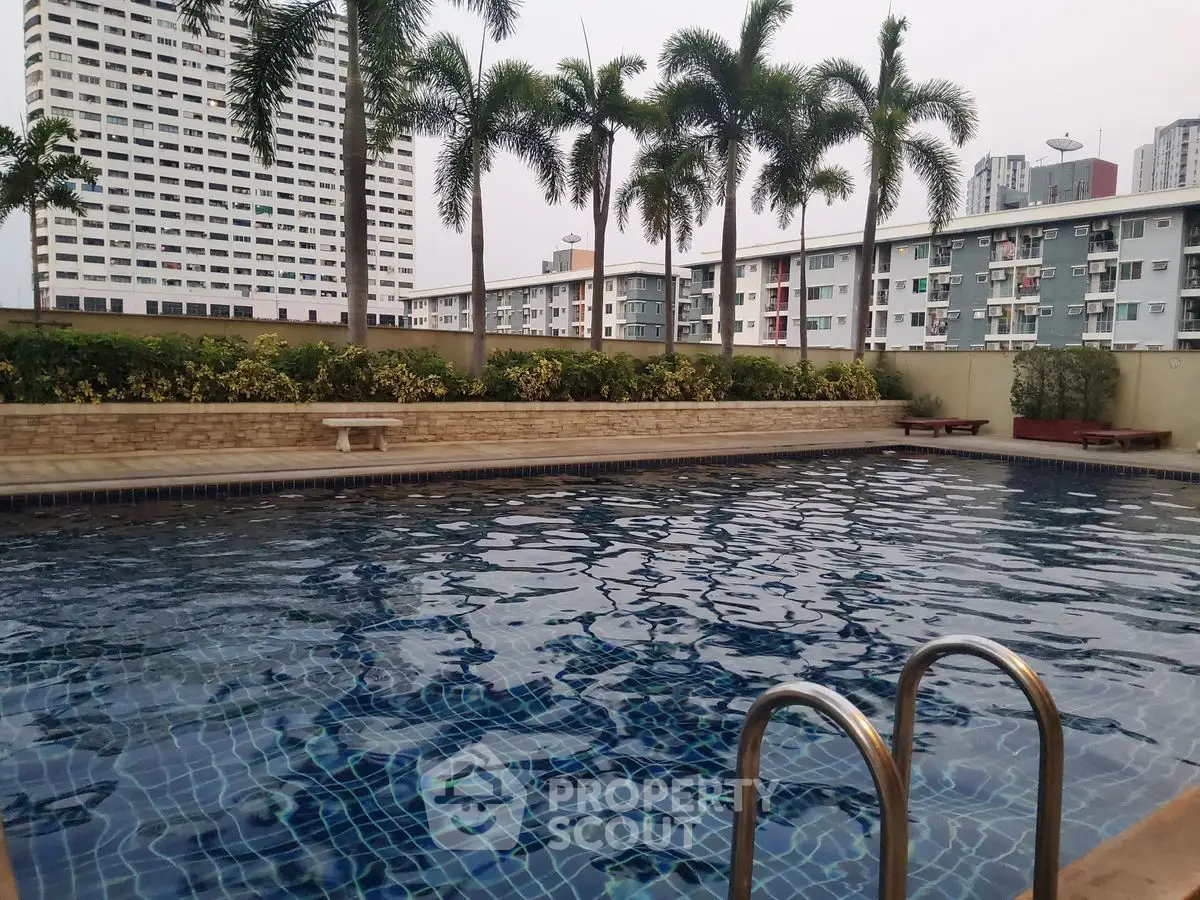 Luxurious rooftop pool with city skyline view and palm trees, perfect for relaxation and leisure.