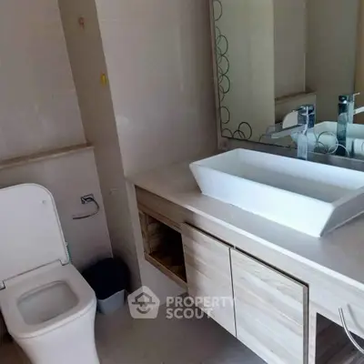 Modern bathroom with sleek vanity and contemporary fixtures.