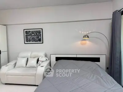 Modern bedroom with sleek white furniture and stylish decor