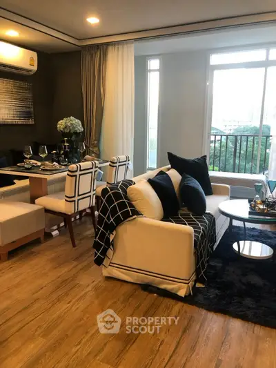 Stylish living room with elegant decor and balcony view, featuring modern furniture and dining area.