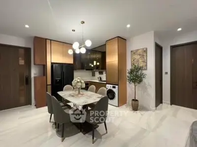 Modern kitchen and dining area with elegant lighting and appliances