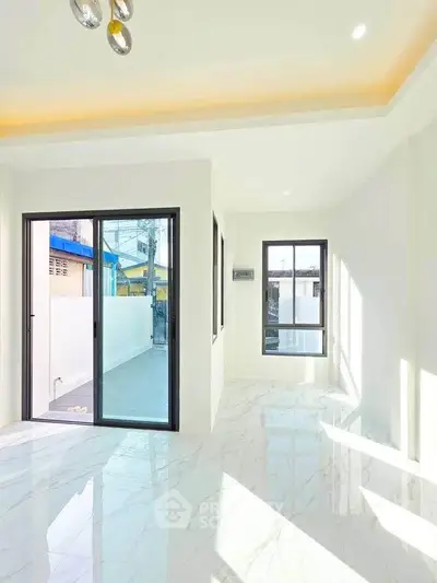 Bright modern living room with large windows and marble flooring