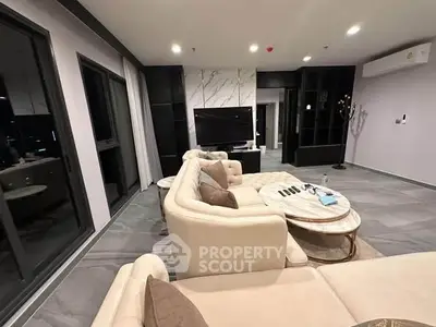 Luxurious modern living room with elegant beige sectional sofa and marble accents