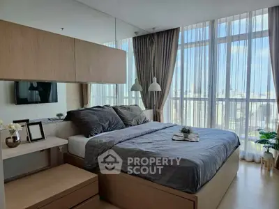 Luxurious bedroom with city view, featuring modern decor and floor-to-ceiling windows.