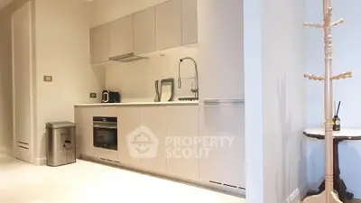 Modern kitchen with sleek cabinetry and built-in appliances in a stylish apartment.
