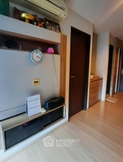 Modern interior hallway with wooden flooring and built-in storage