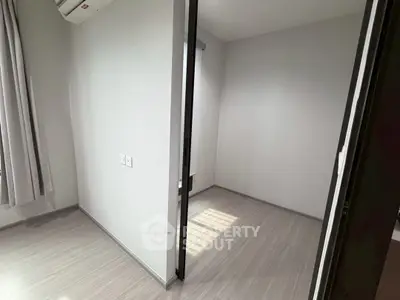 Minimalist interior with light wood flooring and neutral walls, perfect for customization.