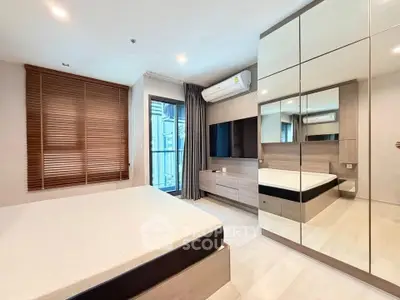 Modern bedroom with mirrored wardrobe and sleek design in a stylish apartment.