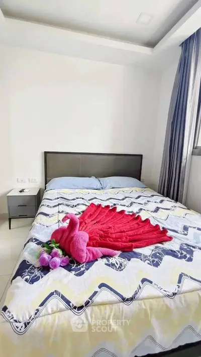 Cozy bedroom with stylish decor and natural light, perfect for relaxation and comfort.
