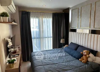 Cozy bedroom with modern decor, plush bedding, and balcony access, perfect for relaxation and comfort.