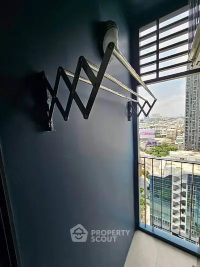 Urban balcony with city view and retractable clothesline, perfect for modern living.